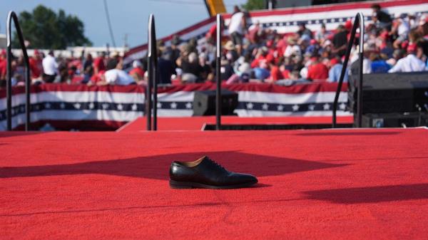 A shoe remains on stage after Trump was taken fro the stage